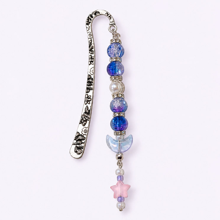 Silver moon bookmark with blue beads and a pink star on a light lavender background